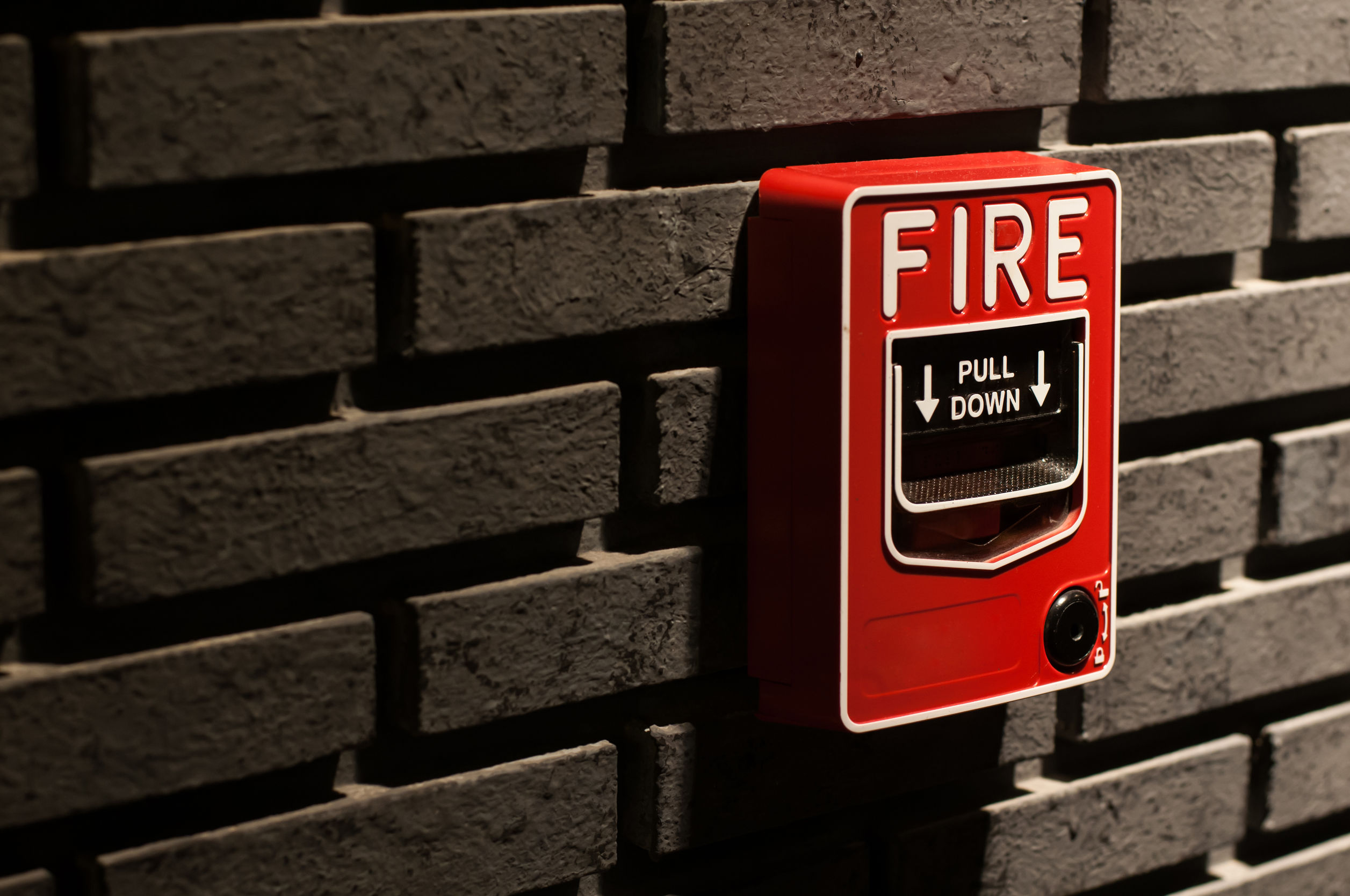 fire alarm on brick wall